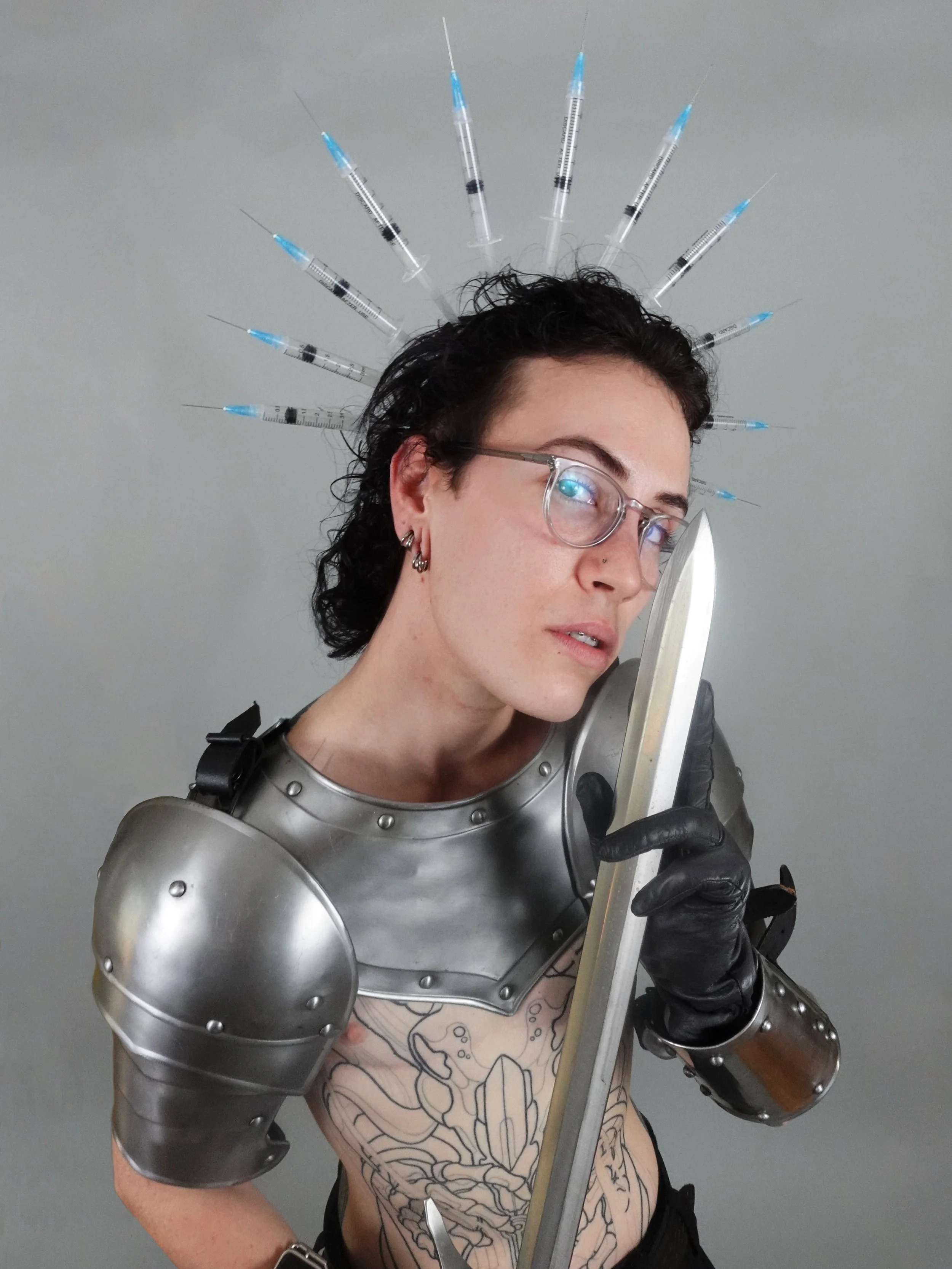 Halo of Sharps — a crown-like sculptural piece constructed from sharp protective elements